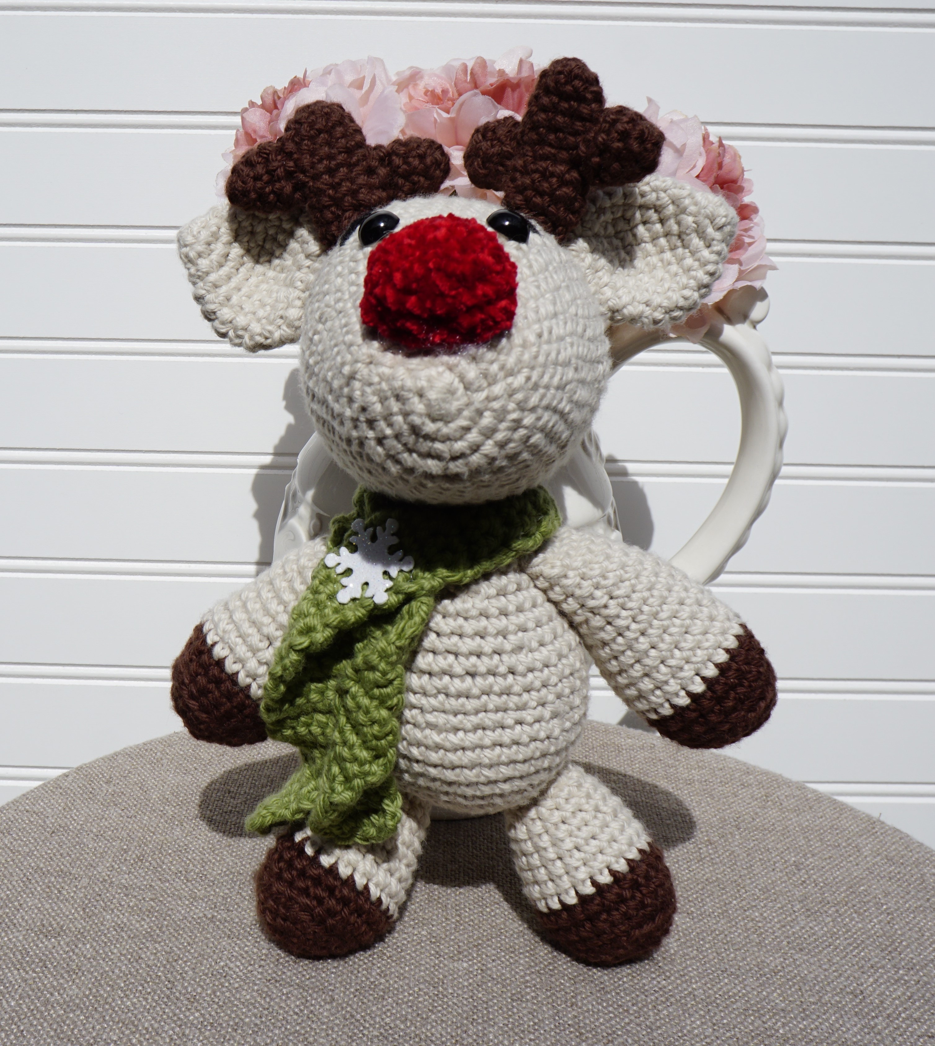Handmade crocheted amigurumi reindeer with scarf